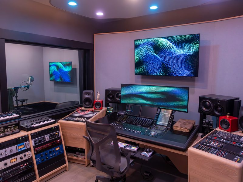 Control room with a mixing surface, monitors and a wraparound desk