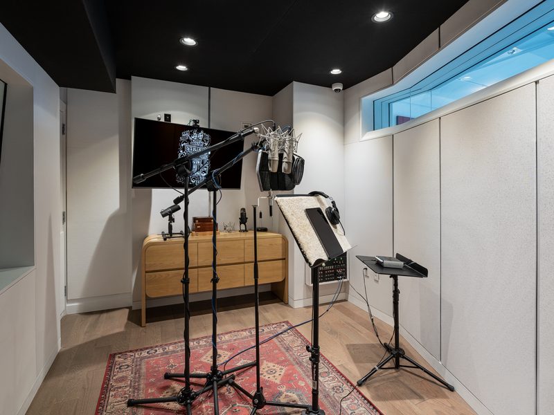 Voiceover booth with microphones and a headphone station