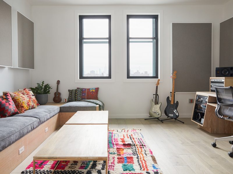 Lounge with built-in seating, guitars and city views