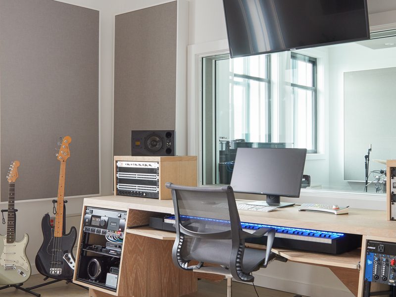 Control room with an editing desk, monitor bridge and live-room window